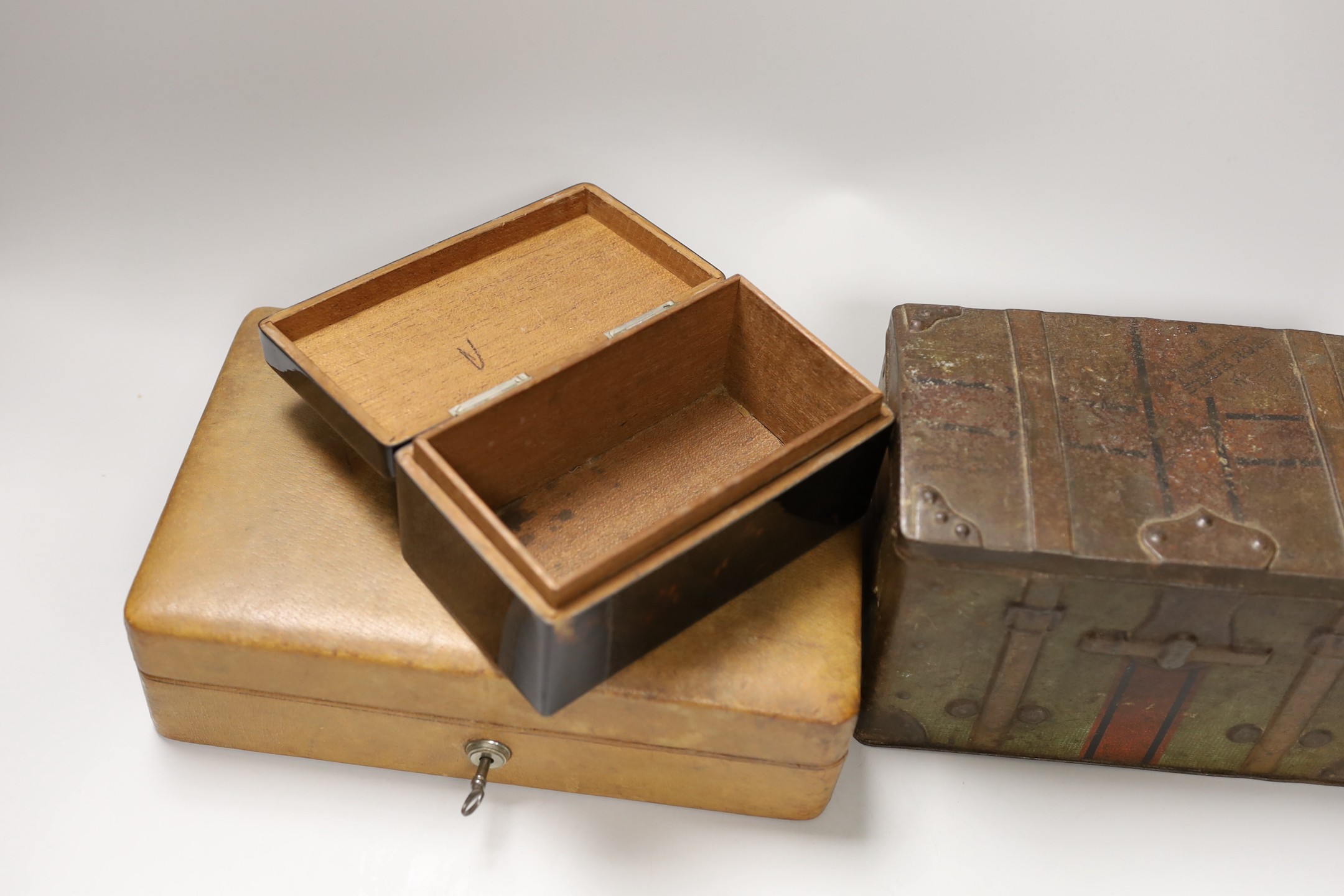 A leather Bramah jewellery case, a tortoiseshell cigarette box and a biscuit box. Widest 25.5cm